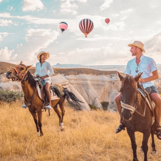 Cappadocia: Horse Riding with Balloons Above at Sunrise